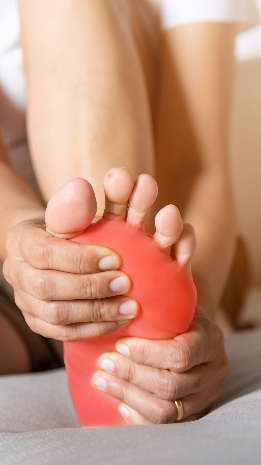 Person holding a painful foot