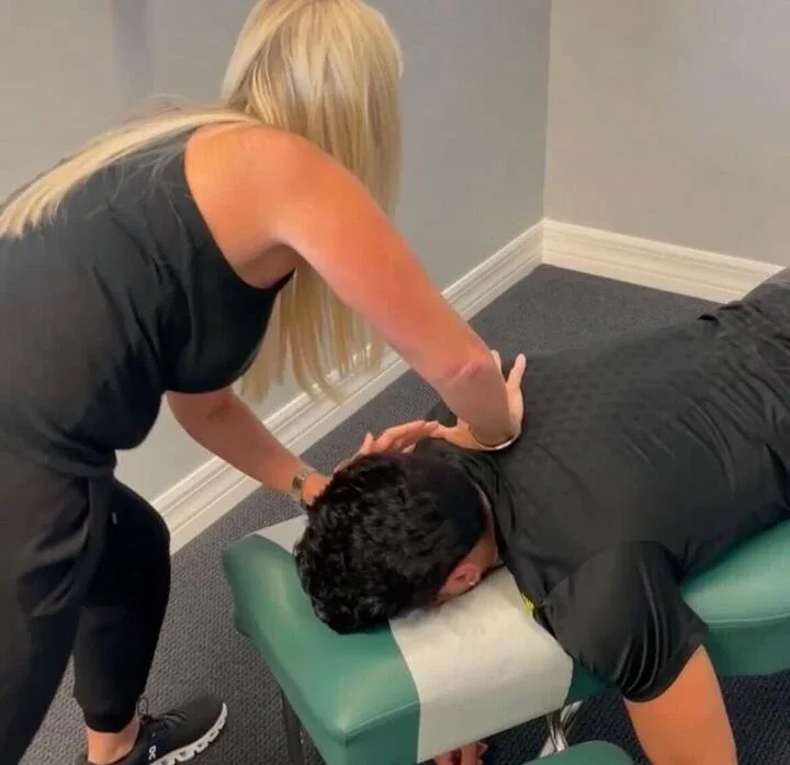 Dr. Kim Raby adjusting a patient's back