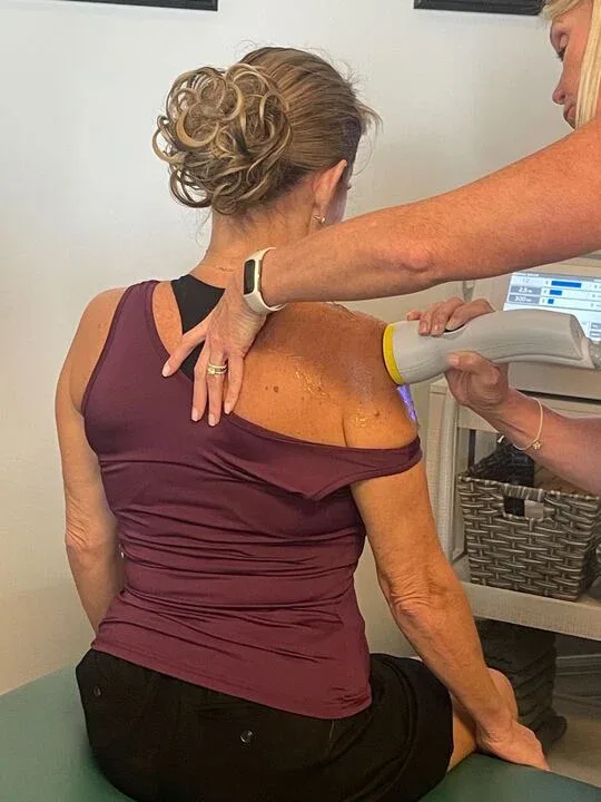 Patient receiving a seated SoftWave therapy session at Dynamic Chiropractic