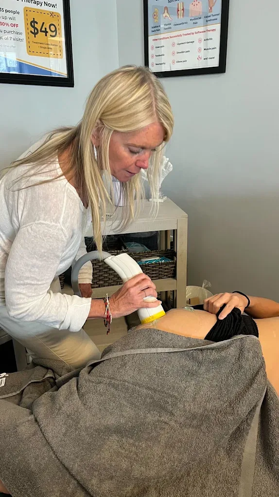 Dr. Kim Raby treating a patient with the SoftWave device