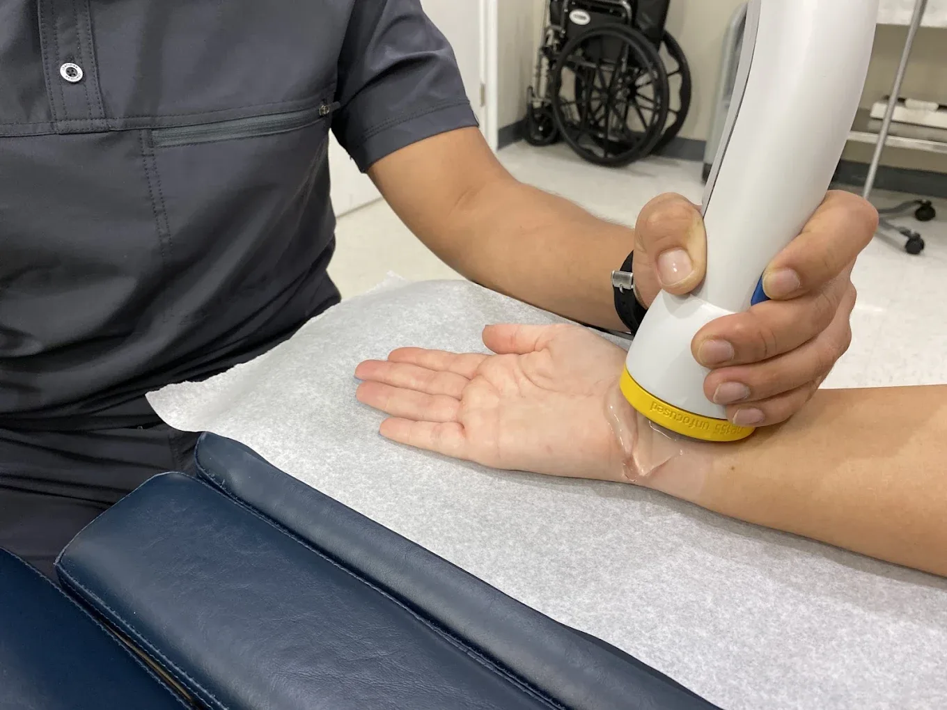 SoftWave therapy applied to a patient's wrist and forearm